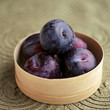 Close up of some plums in a container
