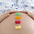 Gummi bears on a pregnant woman's stomach