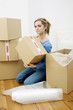 Woman holding a box while looking at the camera