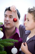 Father and son decorating the Christmas tree