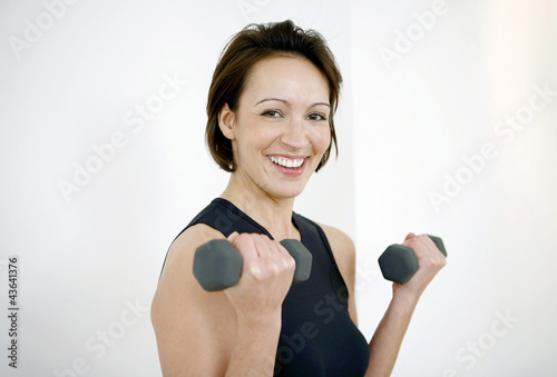 Photo: Woman lifting dumbbells Woman lifting dumbbells