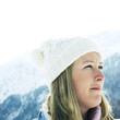 Woman in white knitted hat looking away