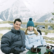 Couple in warm clothing smiling at the camera