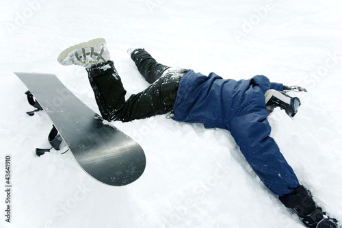 Photo: Snowboarder with his face on the snow Snowboarder with his face on the snow