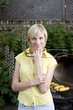 Woman holding tongs in front of the barbeque grill