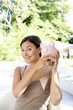Woman holding up her piggy bank