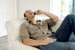 Man talking on the mobile phone while holding credit card