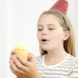 Girl holding cupcake with candle