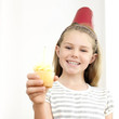 Girl holding cupcake with candle