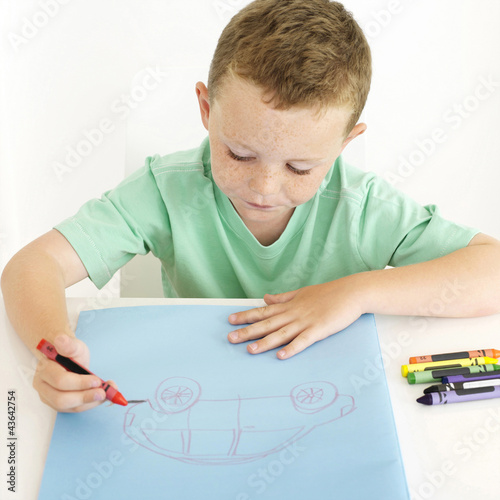 Photo: Boy drawing a car Boy drawing a car