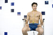 Coach sitting on chair with whistle hanging around his neck