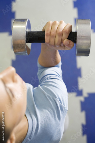 Photo: Woman lifting dumbbell Woman lifting dumbbell