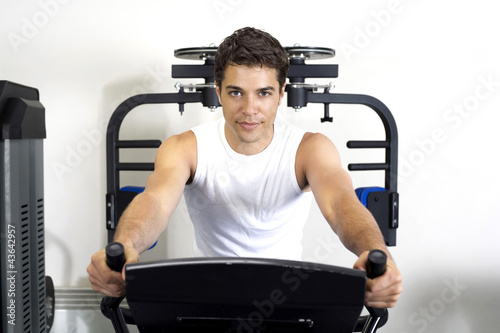 Photo: Man using gym equipment Man using gym equipment