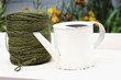 Watering can beside a roll of twine