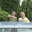 Man and woman washing car together