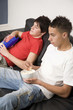 Boys eating popcorn while watching television