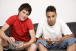 Boys playing video game console