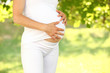 Young and fit pregnant woman in nature