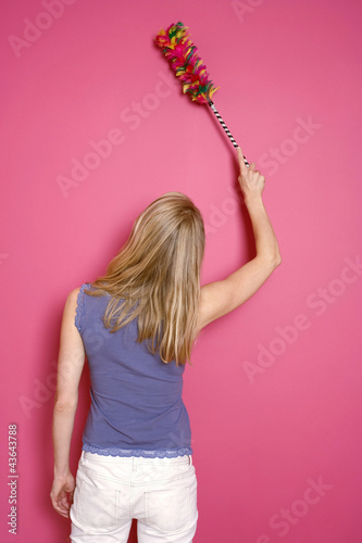 Photo: Woman dusting the wall Woman dusting the wall