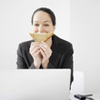 Businesswoman holding sandwich