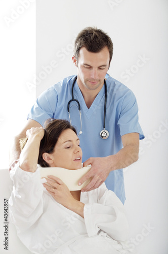 Photo: Male doctor treating a patient Male doctor treating a patient