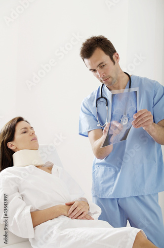Photo: Male doctor treating a patient Male doctor treating a patient
