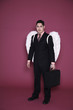 Businessman with angel wings holding a bag