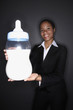 Photo: Businesswoman posing with giant milk bottle Businesswoman posing with giant milk bottle