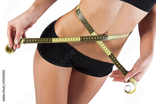 Photo: Thin young woman measures the waist Thin young woman measures the waist