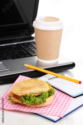 Photo: Eating at work place near laptop Eating at work place near laptop