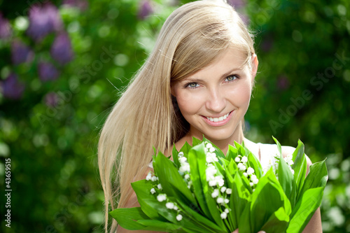 Photo: Portrait of young beautiful smiling woman outdoors Portrait of young beautiful smiling woman outdoors