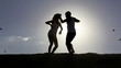Video: Romantic scene: happy couple dancing over sun with flying birds Romantic scene: happy couple dancing over sun with flying birds