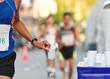 Marathon racer catching cup of water