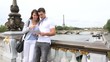 Couple in Paris walking on the bridge Alexander the Third