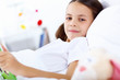Foto: Girl with a book in bed at home Girl with a book in bed at home
