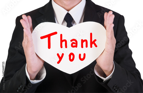 Photo: Businessman holding paper heart shape Businessman holding paper heart shape
