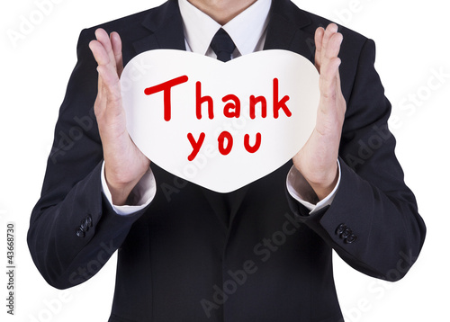 Photo: Businessman holding paper heart shape Businessman holding paper heart shape