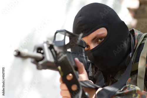 Photo: Terrorist in black mask with a gun Terrorist in black mask with a gun