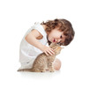 Funny child girl playing with cat kitten