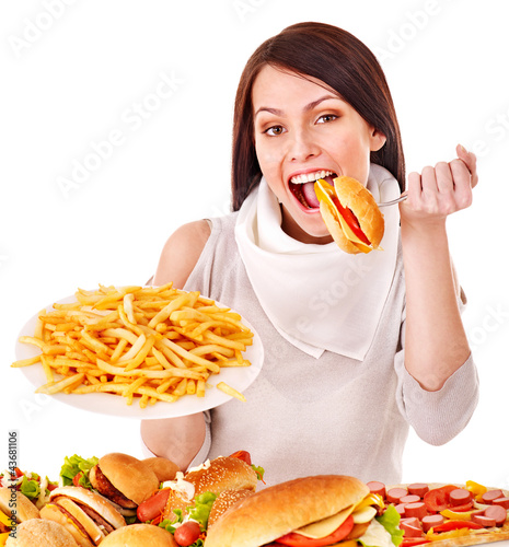 Photo: Woman eating fast food. Woman eating fast food.
