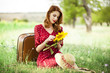 Redhead girl with sunflower at outdoor.
