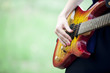 Close-up view at guitar in girl's hands at outdoor.