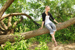 Teen sit on a branch