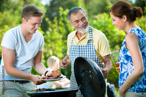 Photo: Family having a barbecue party Family having a barbecue party
