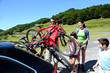 Foto: Family preparing bicycles for recreational journey Family preparing bicycles for recreational journey