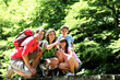 Family on a bridge in mountain observing nature