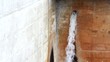 water drain from tube on concrete wall