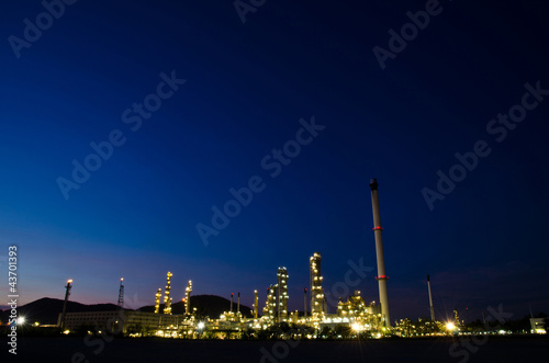 Photo: Petrochemical industry on sunset dark blue sky. Petrochemical industry on sunset dark blue sky.