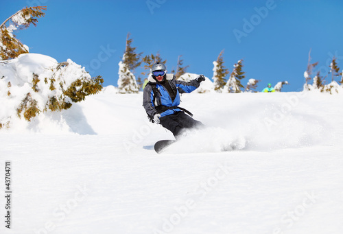 Photo: Snowboarder on a mountain slope Snowboarder on a mountain slope