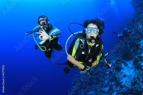 Photo: Couple of friends scuba dive together Couple of friends scuba dive together